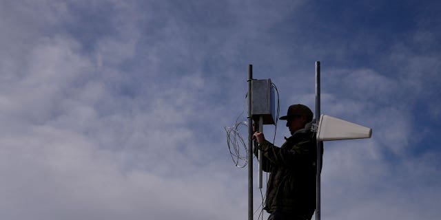 Carver Cammans installs cloud seeding equipment Saturday, Dec. 3, 2022, in Lyons, Colorado, as the Rocky Mountain region struggles with a two-decade drought.