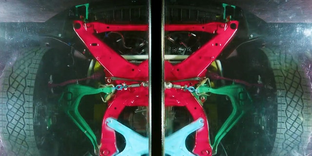 One show reveals the structure of the Cybertruck from underneath a clear floor.