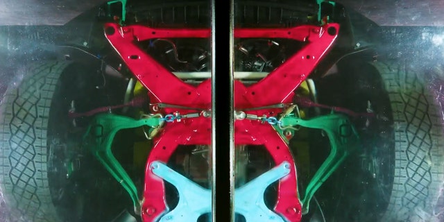 One show reveals the structure of the Cybertruck from underneath a clear floor.