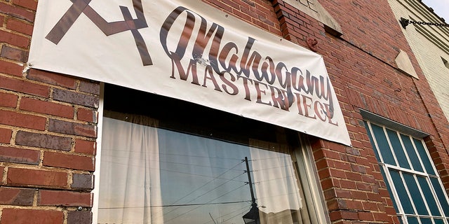 A bullet hole is visible in the glass transom over the door at the Mahogany Masterpiece dance studio in Dadeville, Alabama, on Sunday.