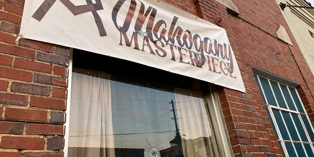 A bullet hole is visible in the glass transom over the door at the Mahogany Masterpiece dance studio in Dadeville, Alabama, on Sunday.