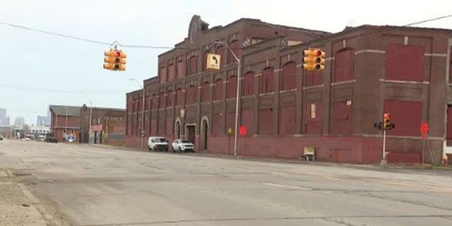 Police have not identified the man who went into this building to reportedly help two dogs when he was mauled to death by them.