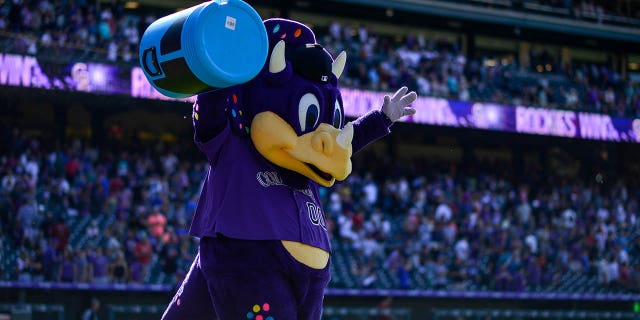 Colorado Rockies mascot Dinger holds an empty Powerade bucket after a win against the Arizona Diamondbacks at Coors Field on Aug. 14, 2019, in Denver.