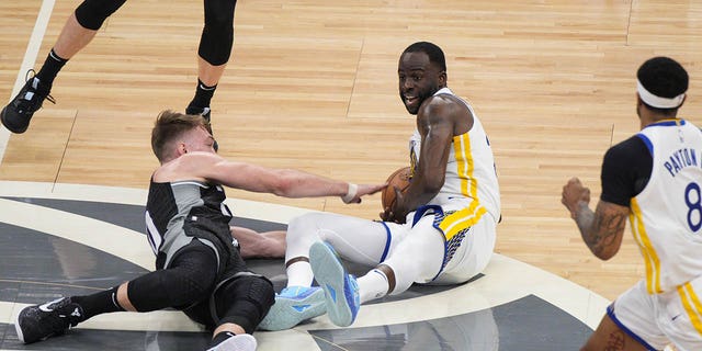 Draymond Green #23 of the Golden State Warriors goes for a loose ball against Domantas Sabonis #10 of the Sacramento Kings during the first quarter of Game One of the Western Conference First Round Playoffs at the Golden 1 Center on April 15, 2023 in Sacramento, California.