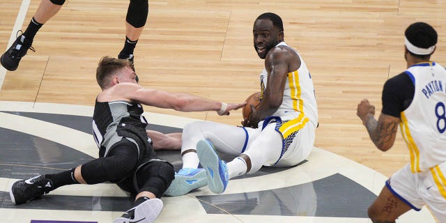 Draymond Green #23 of the Golden State Warriors goes for a loose ball against Domantas Sabonis #10 of the Sacramento Kings during the first quarter of Game One of the Western Conference First Round Playoffs at the Golden 1 Center on April 15, 2023 in Sacramento, California.