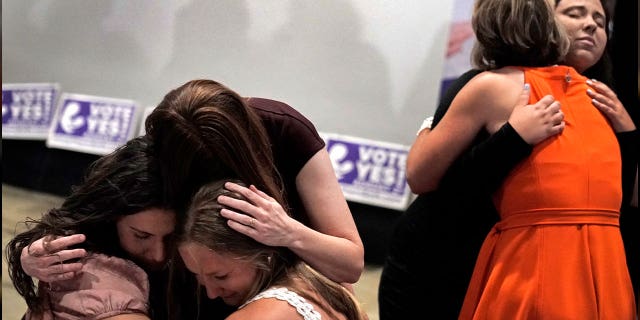 People hug during a watch party after a question involving a constitutional amendment removing abortion protections in Kansas failed on Aug. 2, 2022. Kansas legislators gave final approval to a bill that could subject doctors to lawsuits if they are accused of not providing enough care to infants born during abortion procedures