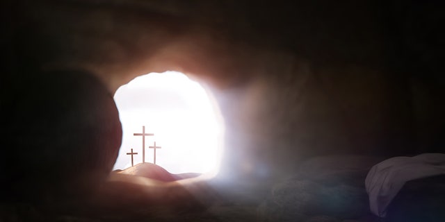 Empty tomb symbolizing the death and resurrection of Jesus Christ Easter and the cross of sacrifice and suffering and bright light background