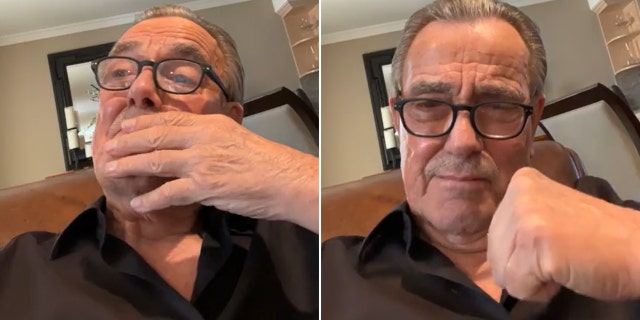 Eric Braeden in a black shirt and black rimmed glasses bring his hand to his face, emotional split puts his fist in the air