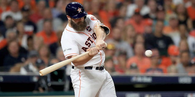 Evan Gattis #11 of the Houston Astros hits a a solo home run against CC Sabathia #52 of the New York Yankees during the fourth inning in Game Seven of the American League Championship Series at Minute Maid Park on October 21, 2017 in Houston, Texas.