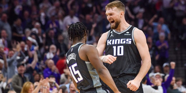 Sacramento Kings forward Domantas Sabonis (10) congratulates guard Davion Mitchell (15) in the first half during Game 1 in the first round of the NBA basketball playoffs against the Golden State Warriors in Sacramento, Calif., Monday, April 17, 2023. 