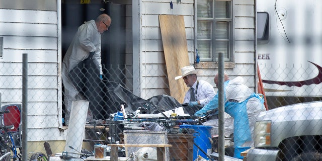Investigators take items out of Cleveland, Texas, shooting scene