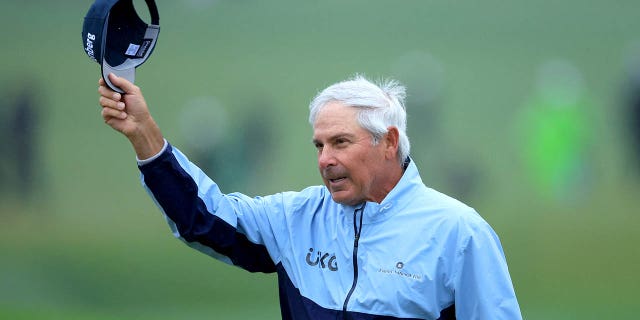 Fred Couples of The United States acknowledges the patrons as he walks off the 18th green having made the cut on one over par during the completion of the weather-delayed second round of the 2023 Masters Tournament at Augusta National Golf Club on April 8, 2023 in Augusta, Georgia.