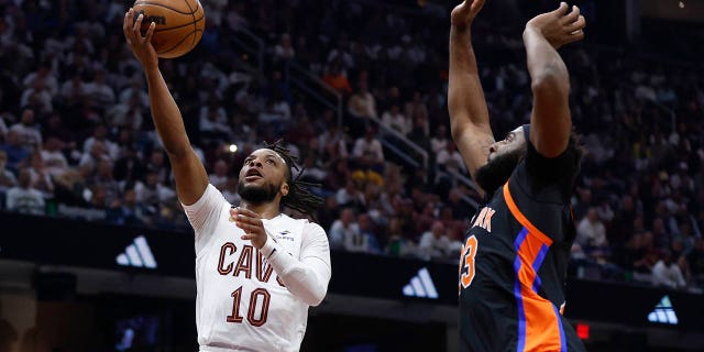 Cleveland Cavaliers guard Darius Garland (10) shoots against New York Knicks center Mitchell Robinson during the first half of Game 2 of an NBA basketball first-round playoff series Tuesday, April 18, 2023, in Cleveland.