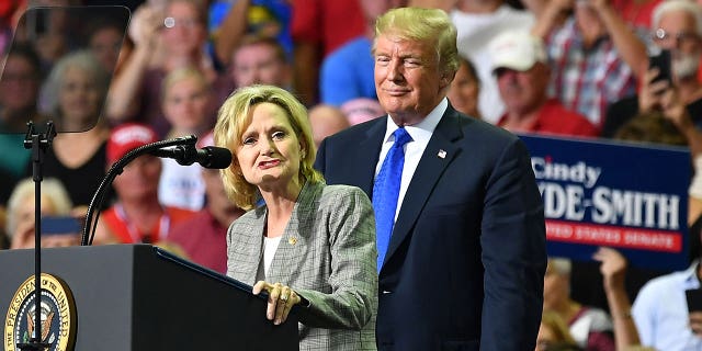 Sen. Cindy Hyde-Smith (R-MS), left, became the sixth senator to publicly endorse former President Trump's presidential run, hours before he pled not guilty at his scheduled arraignment.