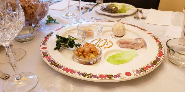 Above, a seder plate for Passover shown on a table.