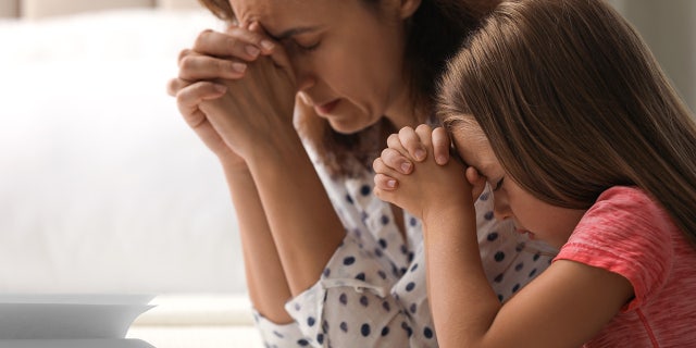 woman daughter pray