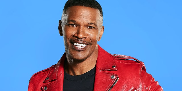 Jamie Foxx wears red leather jacket and black shirt for portrait