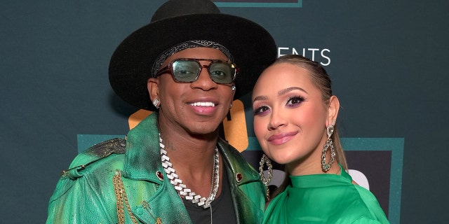 Jimmie Allen smiling with his wife