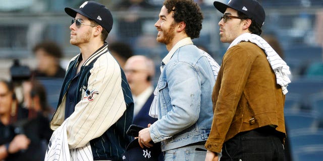 Nick Jonas, Kevin Jonas and Joe Jonas look on before the first inning between the New York Yankees and the Philadelphia Phillies at Yankee Stadium on April 4, 2023 in the Bronx borough of New York City.