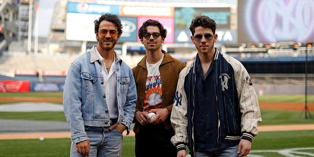 The Jonas Brothers attend the game between the Philadelphia Phillies and the New York Yankees at Yankee Stadium on April 4, 2023 in New York, New York.