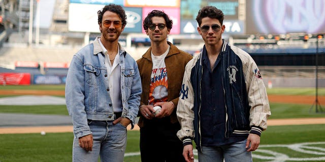 The Jonas Brothers attend the game between the Philadelphia Phillies and the New York Yankees at Yankee Stadium on April 4, 2023 in New York, New York.