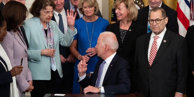President Biden is holding up his hand as California Democrat US Senator Dianne Feinstein did not get a commemorative pen after she signed the VOCA Fix to Sustain the Crime Victims Fund Act of 2021, HR 1652, which changes financial penalties. Victims Compensation Fund, during a ceremony in the East Room of the White House in Washington, DC, on July 22, 2021.