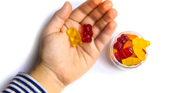 Kid's hand with gummies