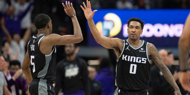 Sacramento Kings guards De'Aaron Fox (5) and Malik Monk (0) celebrate in the third quarter during Game 1 against the Golden Sate Warriors in the first round of the NBA basketball playoffs in Sacramento, Calif., Saturday, April 15, 2023. The Kings won 126 - 123.