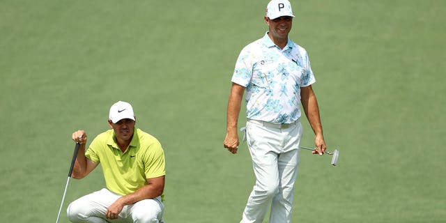 Brooks Koepka, left and Gary Woodland look on from the second green during the first round of the 2023 Masters Tournament at Augusta National Golf Club in Augusta, Georgia, on Thursday.