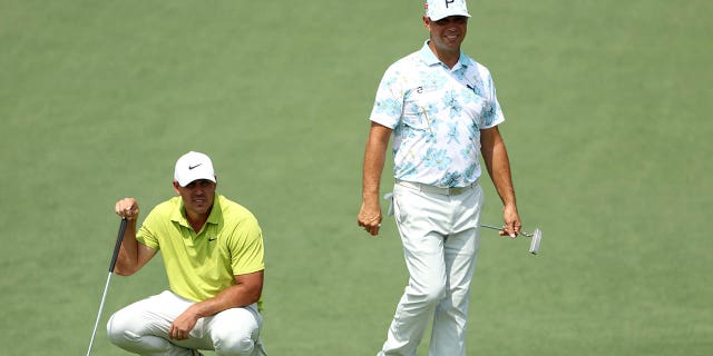 Brooks Koepka, left and Gary Woodland look on from the second green during the first round of the 2023 Masters Tournament at Augusta National Golf Club in Augusta, Georgia, on Thursday.