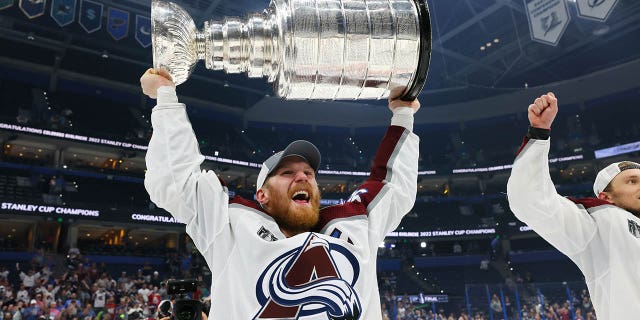 Gabriel Landeskog #92 of the Colorado Avalanche lifts the Stanley Cup after defeating the Tampa Bay Lightning 2-1 in Game Six of the 2022 NHL Stanley Cup Final at Amalie Arena on June 26, 2022 in Tampa, Florida.
