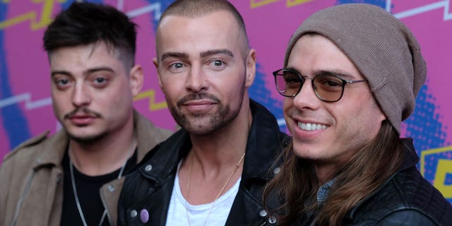 Lawrence brothers stand next to each other at Hollywood party