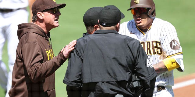 Manager Bob Melvin, left, argues with umpire Ron Kulpa after Manny Machado, right, of the San Diego Padres was called out on a timed third strike during the first inning of a game against the Arizona Diamondbacks at PETCO Park April 4, 2023, in San Diego.