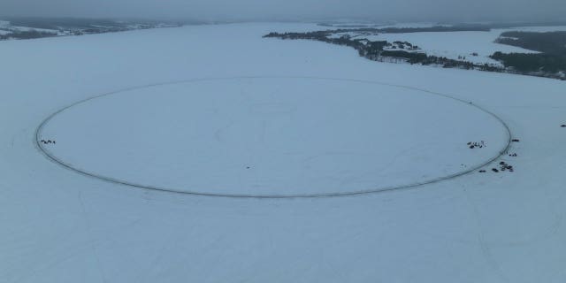 Volunteers carved out a 1,776-foot, 146,000-ton "ice carousel" in a Maine lake.