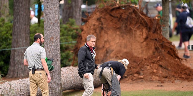 AUGUSTA, GEORGIA - APRIL 07: Course officials look over fallen trees on the 17th hole during the second round of the 2023 Masters Tournament at Augusta National Golf Club on April 07, 2023 in Augusta, Georgia. 