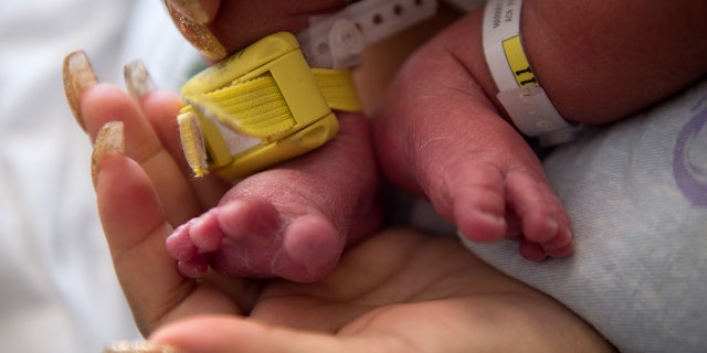 Close up of a mother holding her baby in the hospital