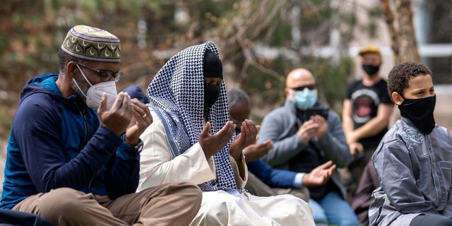 People attend the first Friday prayers of the Islamic holy month of Ramadan outside the Hennepin County Government Center in Minneapolis, Minnesota on April 16, 2021.