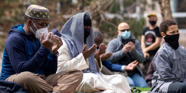 People attend the first Friday prayers of the Islamic holy month of Ramadan outside the Hennepin County Government Center in Minneapolis, Minnesota on April 16, 2021.