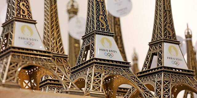 Replicas of the Eiffel Tower with the logo of the 2024 Olympic Games for the Paris 2024 Summer Olympic and Paralympic Games are displayed inside the official store Nov. 15, 2022, in Paris.