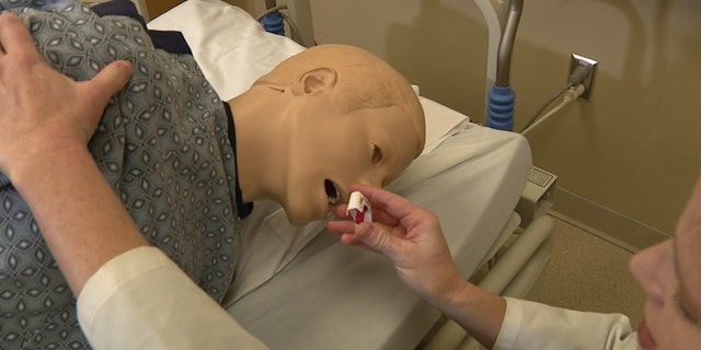 Dr. Holly Geyer demonstrates how to use the nasal spray that reverses overdoses on a dummy. "There was a 30% increase in overdose dose in 2020 and another 15% increase in 2021. Who knows what 2022 will show," Dr. Geyer said. 