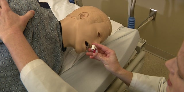 Dr. Holly Geyer demonstrates how to use the nasal spray that reverses overdoses on a dummy. "There was a 30% increase in overdose dose in 2020 and another 15% increase in 2021. Who knows what 2022 will show," Dr. Geyer said. 