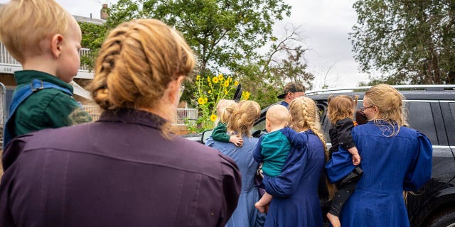 Family and followers of a polygamous leader Samuel Bateman gather following his arrest in Colorado City, Arizona, on Sept. 13, 2022.