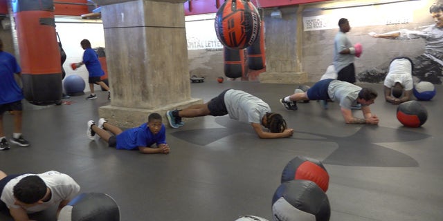 Baltimore boys and police do a fitness challenge together