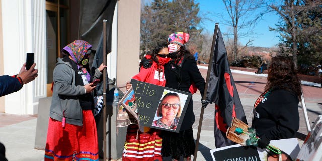 Seraphine Warren, center left, is embraced by state Sen. Shannon Pinto outside the state capitol building on Feb. 4, 2022, in Santa Fe, New Mexico. They participated in a rally to draw attention to murdered and missing Indigenous people including Warren’s aunt Ella Mae Begay.