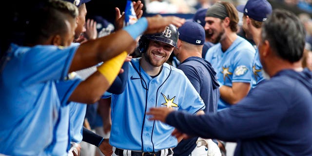 Brandon Lowe of the Tampa Bay Rays celebrates with teammates in the dugout after hitting a home run during the sixth inning against the Oakland Athletics at Tropicana Field April 8, 2023, in St Petersburg, Fla.