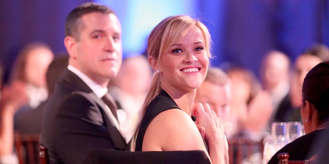 Reese Witherspoon smiles at awards show with Jim Toth in background