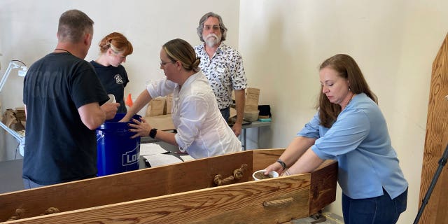 Historians and archaeologists are reburying 12 Continental soldiers whose remains were found in South Carolina after administering a memorial service for them.