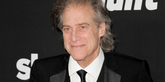 Richard Lewis poses at a movie premiere.