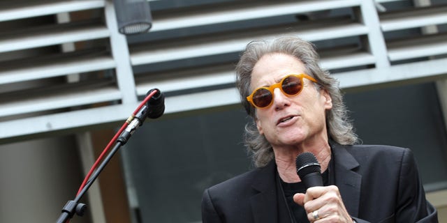 Richard Lewis performs at an event.