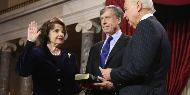 FILE - Sen. Dianne Feinstein, D-Calif., with her husband Richard C. Bloom and U.S. Vice President Joe Biden participate in a swearing-in ceremony in the Old Senate Chamber of the U.S. Capitol January 3, 2013 in Washington. DC